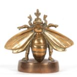 A large vintage bronze bee desk paperweight the base marked with letters and devices, the wingspan