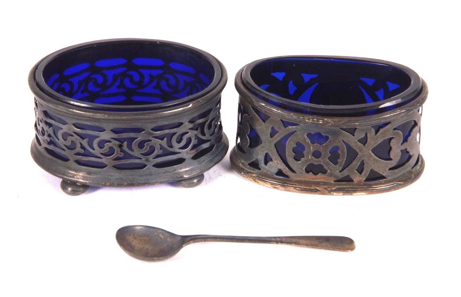 Two early 19th Century silver oval pierced salts with blue glass liners, hallmarked for Chester 1904