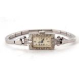 A precious metal and diamond surrounded wristwatch, the case back is stamped on the inside Platt, it