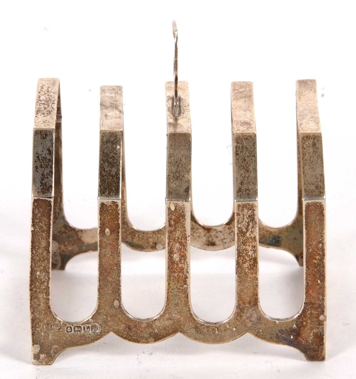 An Art Deco silver toast rack of angular form, four divisions with central loop carrying handle, - Image 2 of 2