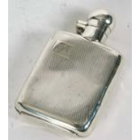 An Art Deco silver small spirit flask of shaped rectangular form, engine turned decorated front