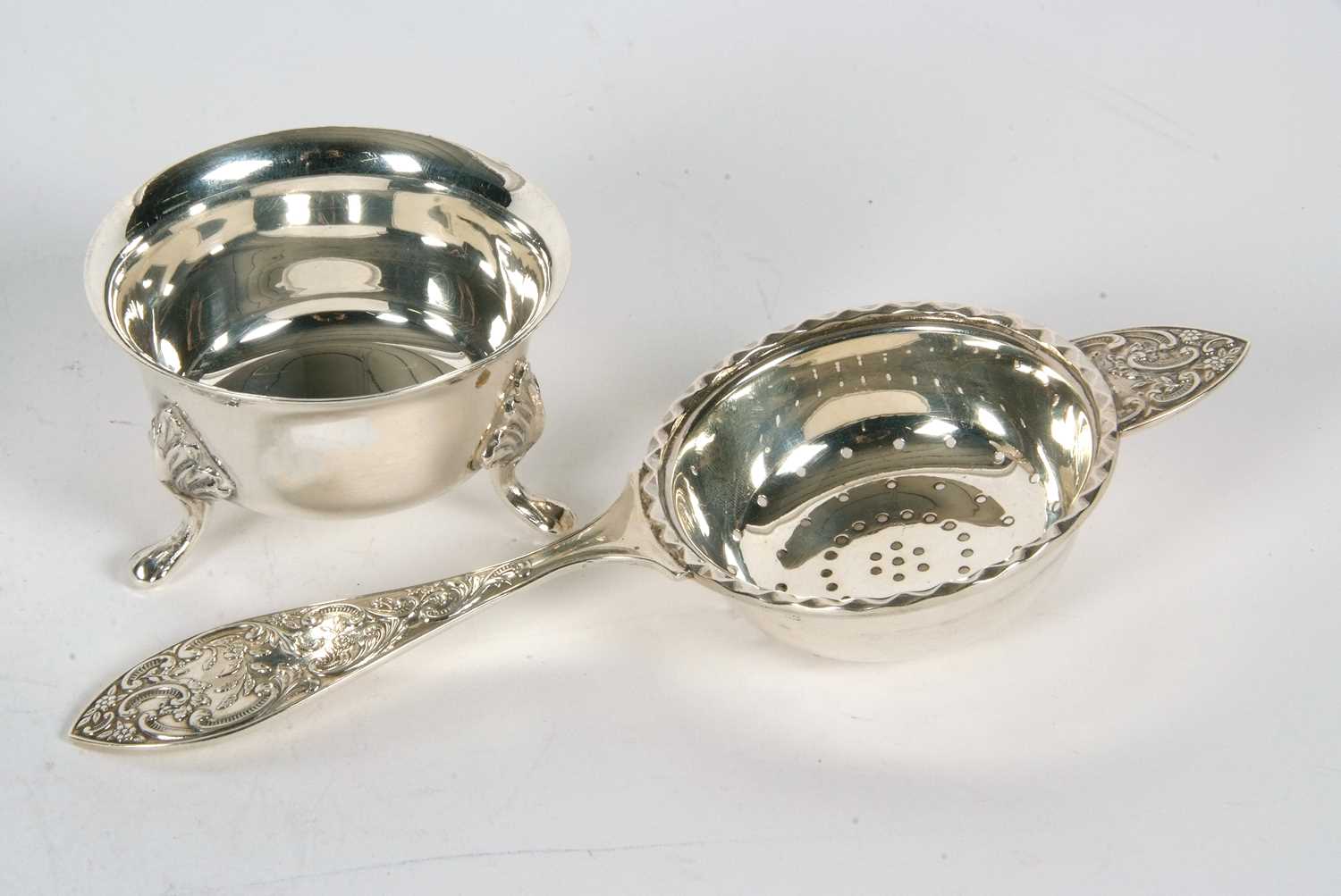 A hallmarked silver tea strainer and bowl, the tea strainer with pierced bowl and applied wavey - Image 2 of 3