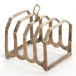 An Art Deco silver toast rack of angular form, four divisions with central loop carrying handle,