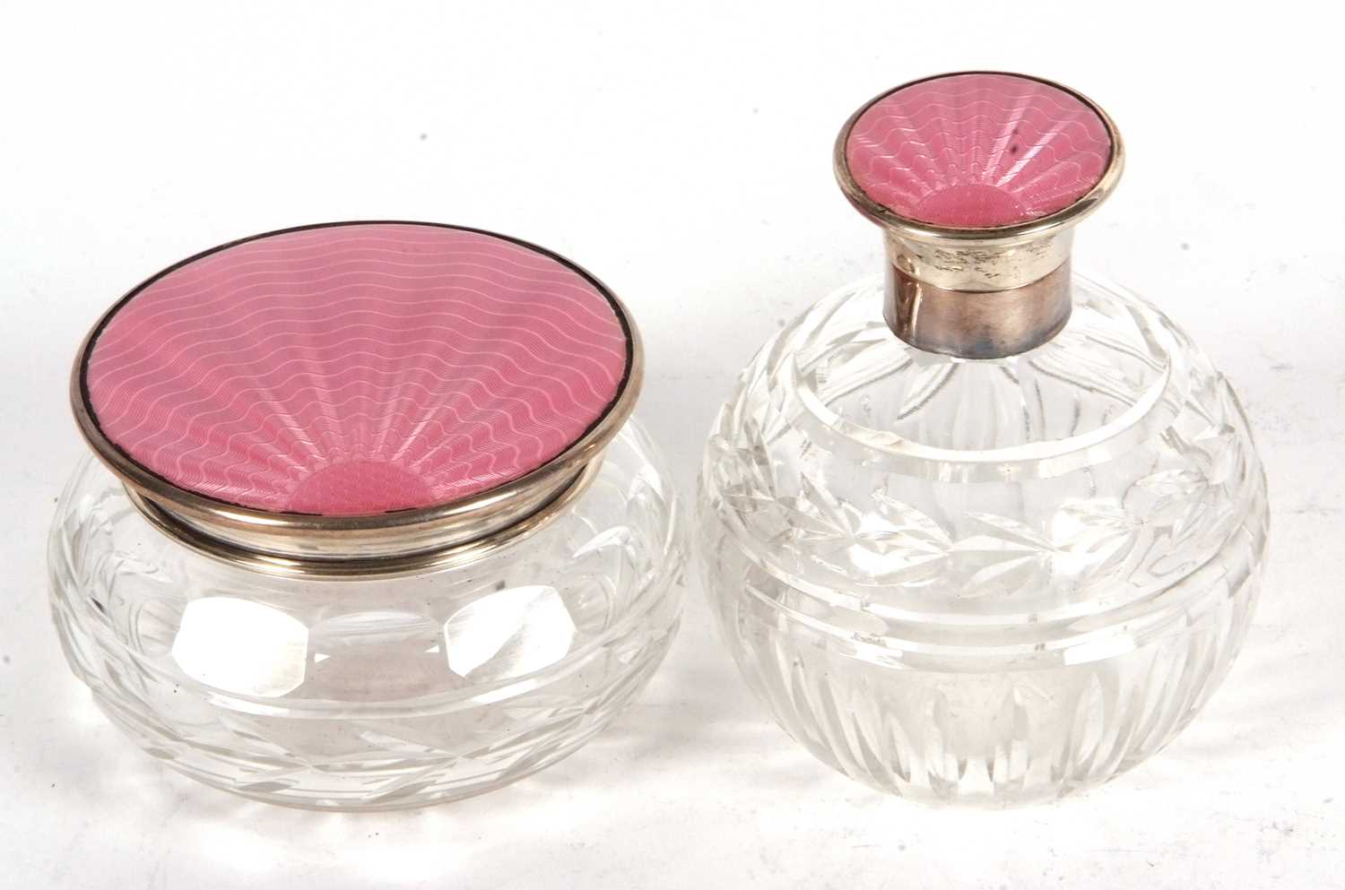 An Art Deco glass dressing table scent and powder bowl, each with pink enamel guilloche decoration