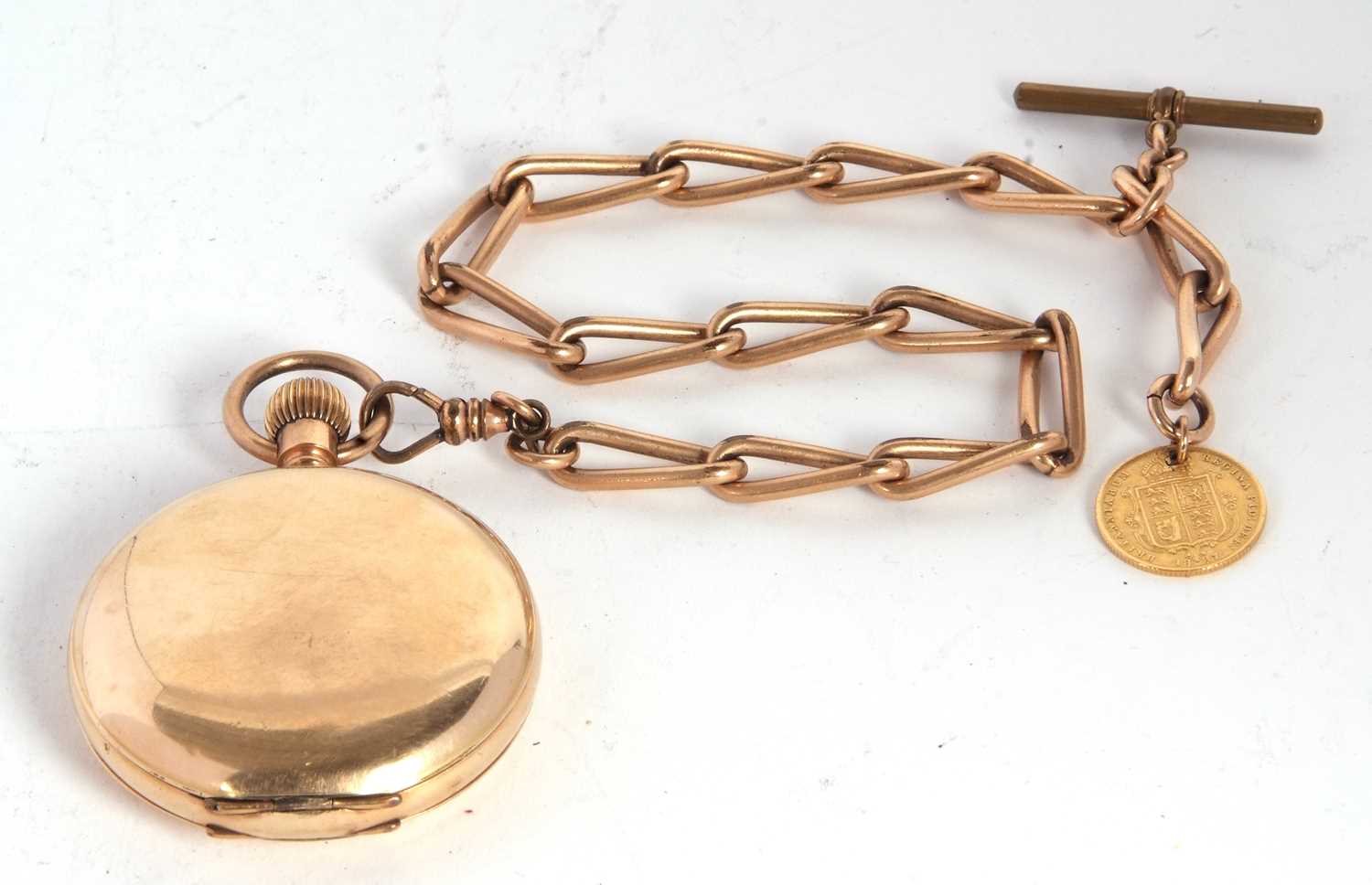 A rolled gold Waltham Hunter pocket watch with a rolled gold chain suspending a half sovereign,