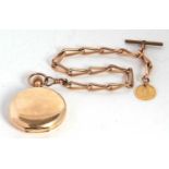 A rolled gold Waltham Hunter pocket watch with a rolled gold chain suspending a half sovereign,