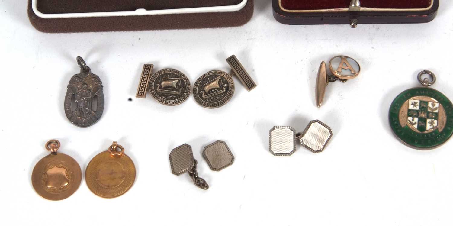 Mixed Lot: Two 9ct gold fobs, one engraved to the back, 5.0gms, a siver gilt and enamel athletics - Image 2 of 3