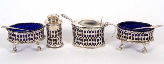 A Martin Hall & Co four piece condiment set of pierced design, each with blue glass liners and