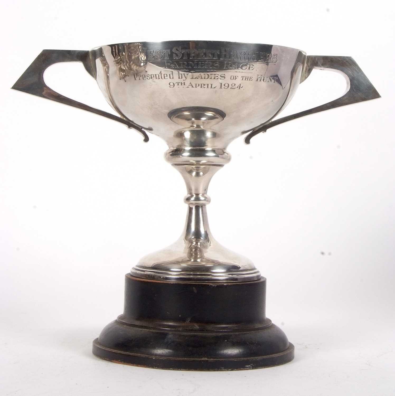 A George V twin handled trophy of plain form with hollow angular handles, engraved "West Street