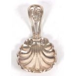 A Victorian silver caddy spoon with a large shell bowl vine leaf pierced handle, hallmarked for