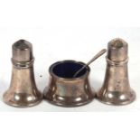 A Elizabeth II silver three piece condiment set comprising salt, pepper, mustard and liner,