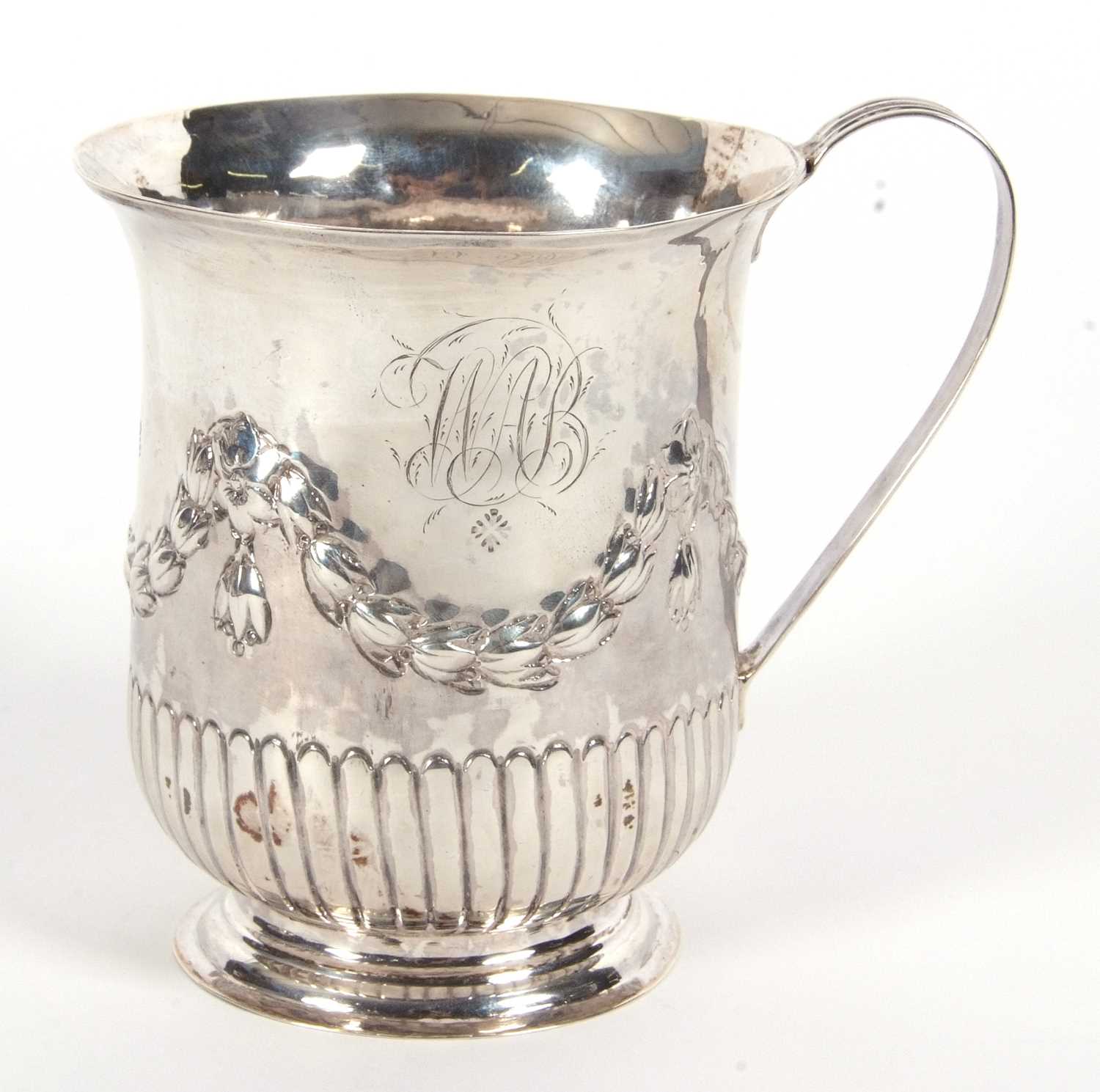 A George III silver mug of slight baluster shape having a reeded handle, garland and fluted - Image 2 of 4