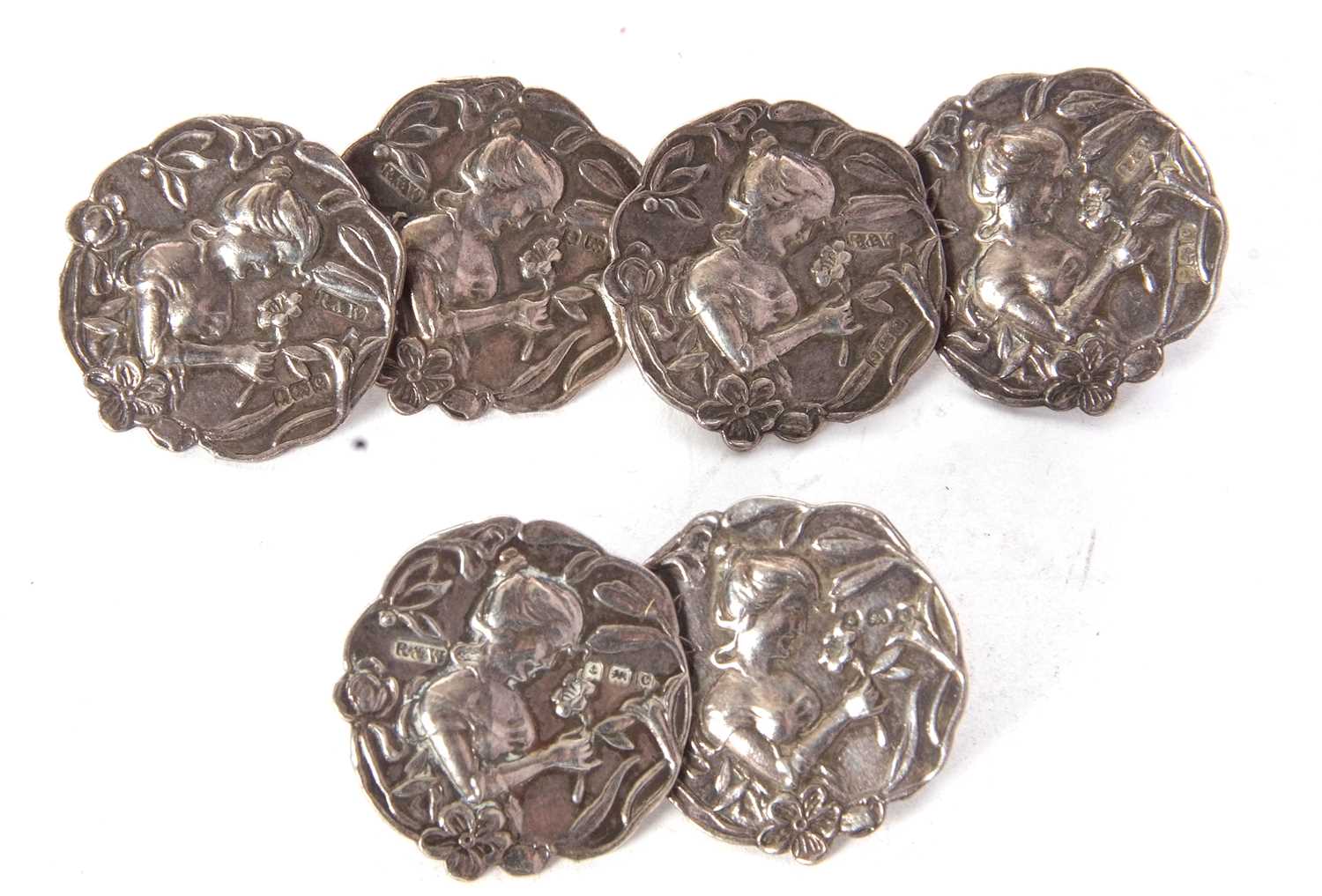 A set of six silver Art Nouveau silver buttons with a shaped outline depicting a head and