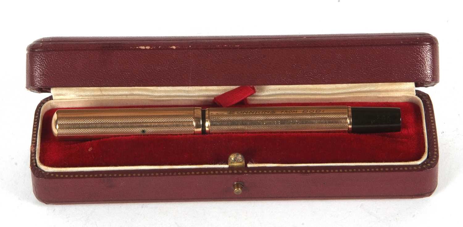 A Watermans Ideal 9ct gold cased fountain pen, engine turned decorated barrel and screw off cap,