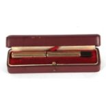 A Watermans Ideal 9ct gold cased fountain pen, engine turned decorated barrel and screw off cap,