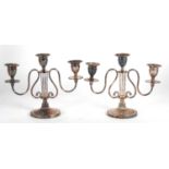 A pair of Barker Ellis silver-plated candelabra, circa 1920 with a lyre design, supporting a