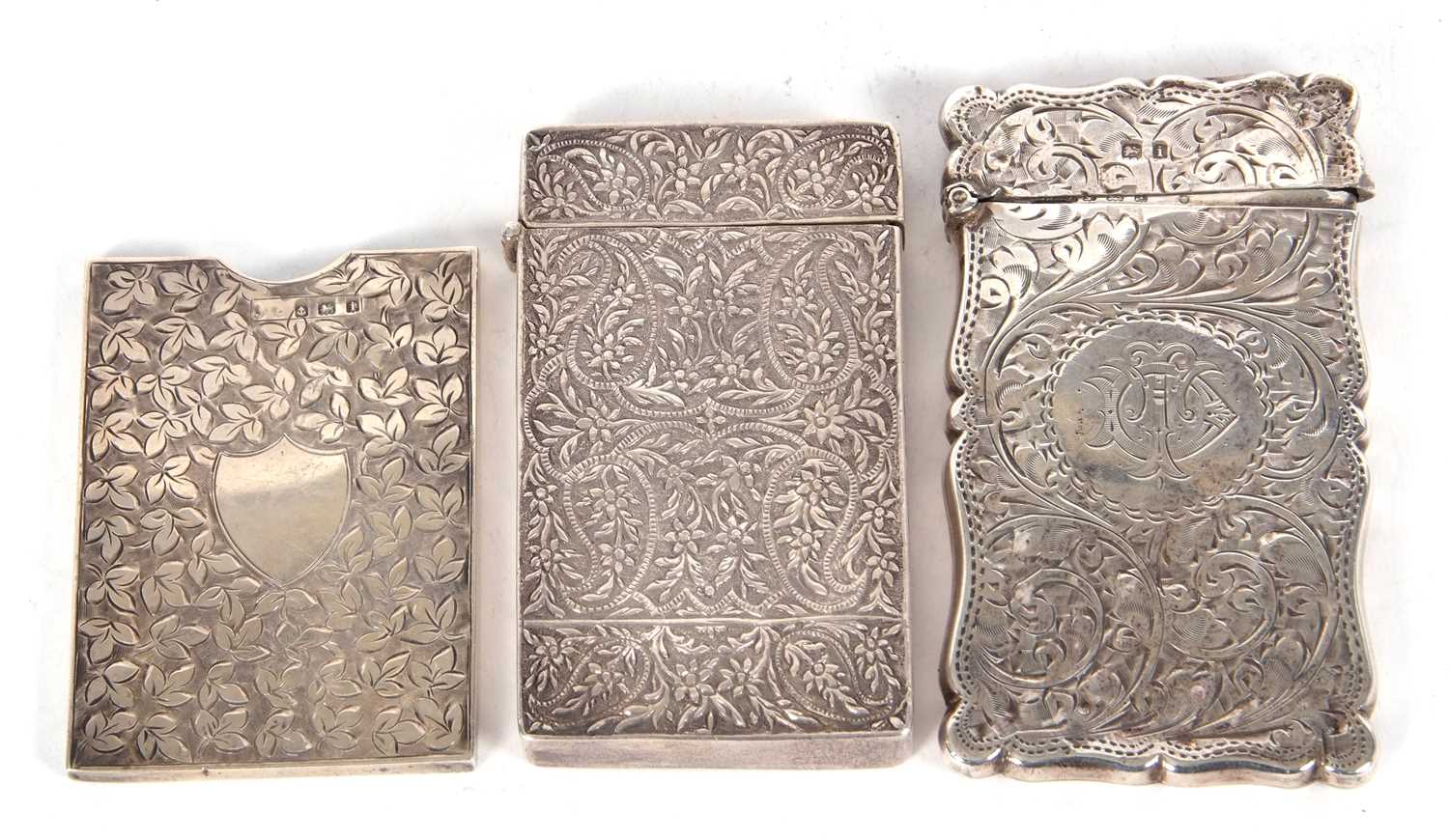 Mixed Lot: An Edwardian silver card case of shaped rectangular form, hinged lid chased and