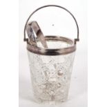 A vintage cut glass ice bucket with silver plated rim and swing handle drainer together with a