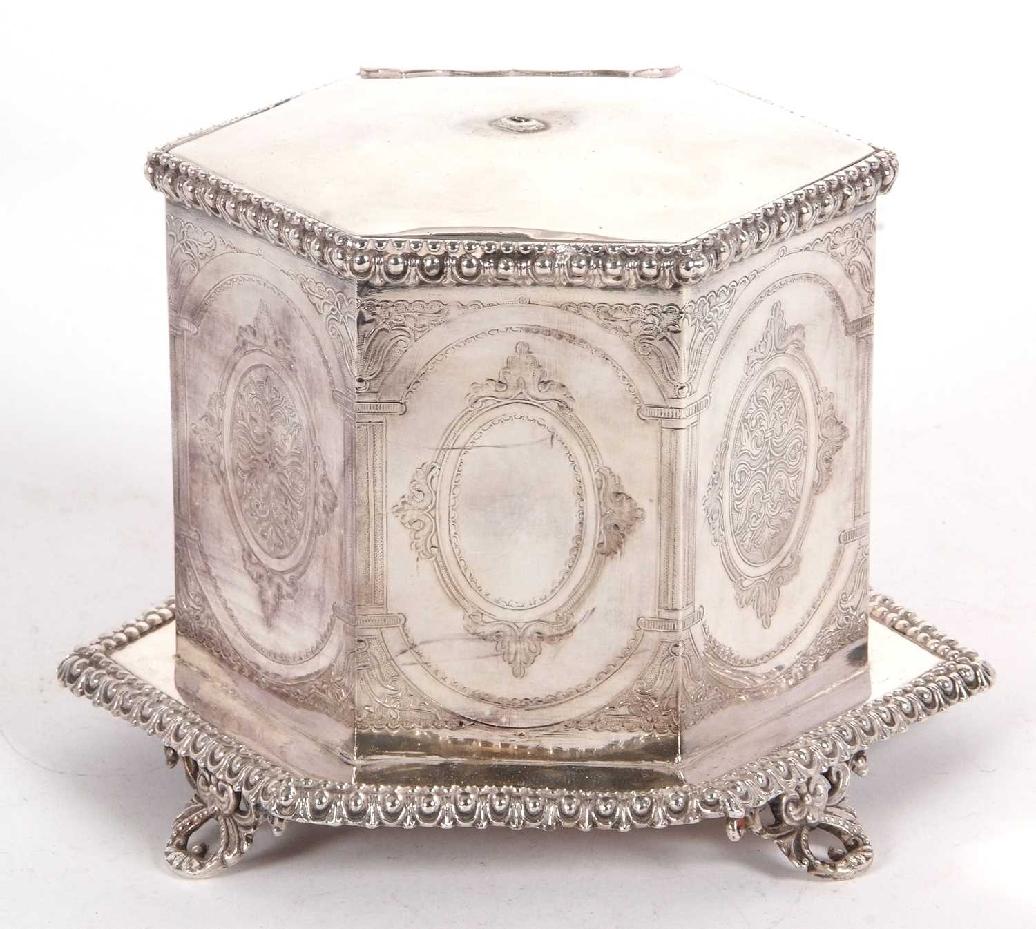 An early 19th Century silver plated biscuit barrel of hexagonal form on integral gadrooned decorated