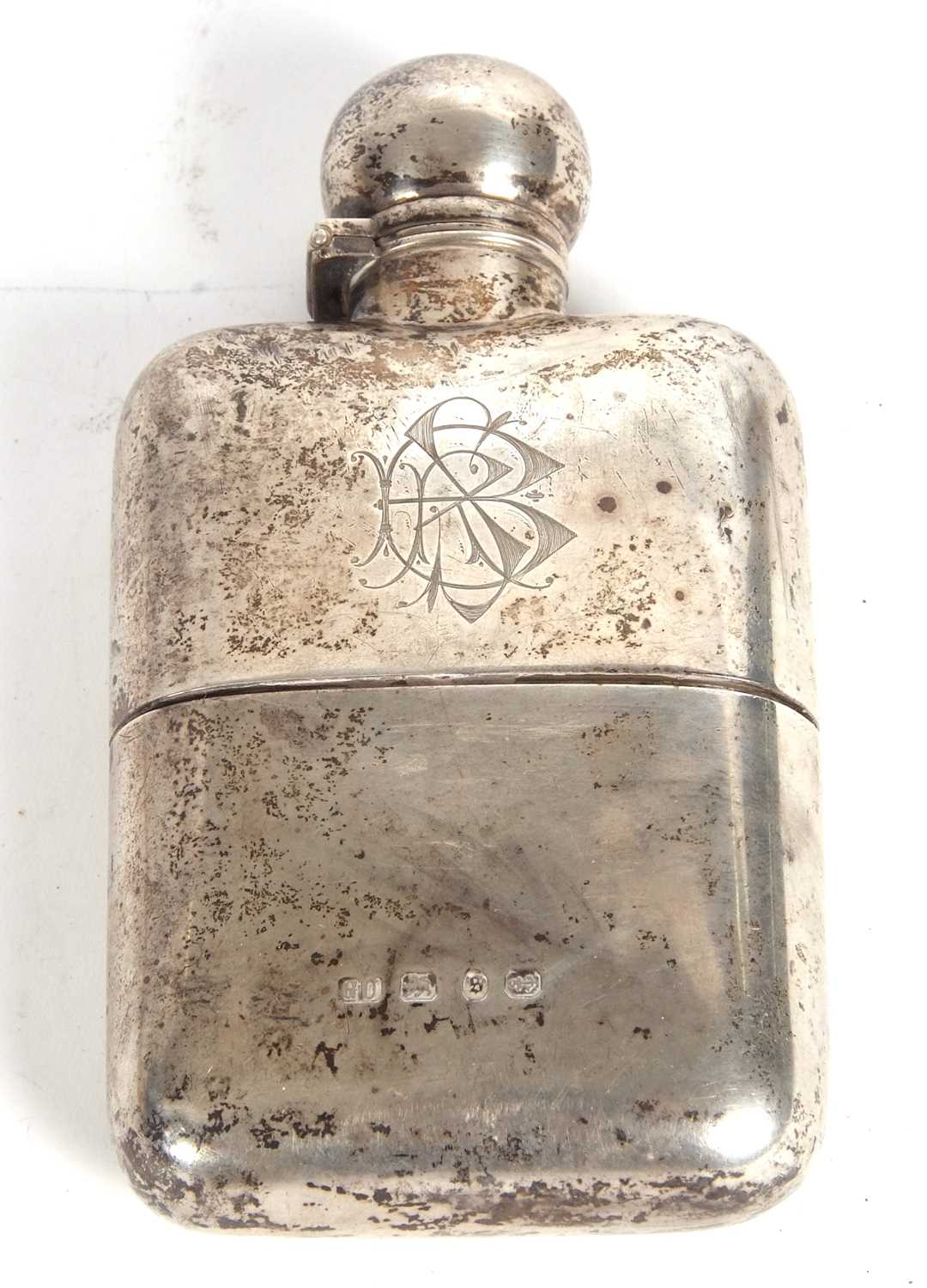 A late Victorian silver spirit flask, the front with a monogram, the verso engraved with a Griffin