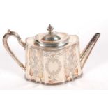 A Victorian silver teapot of shaped oval form, the panelled sides chased and engraved with a
