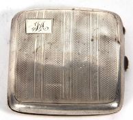 A George V silver cigarette case of square form, engine turn decorated and initialled (a/f),