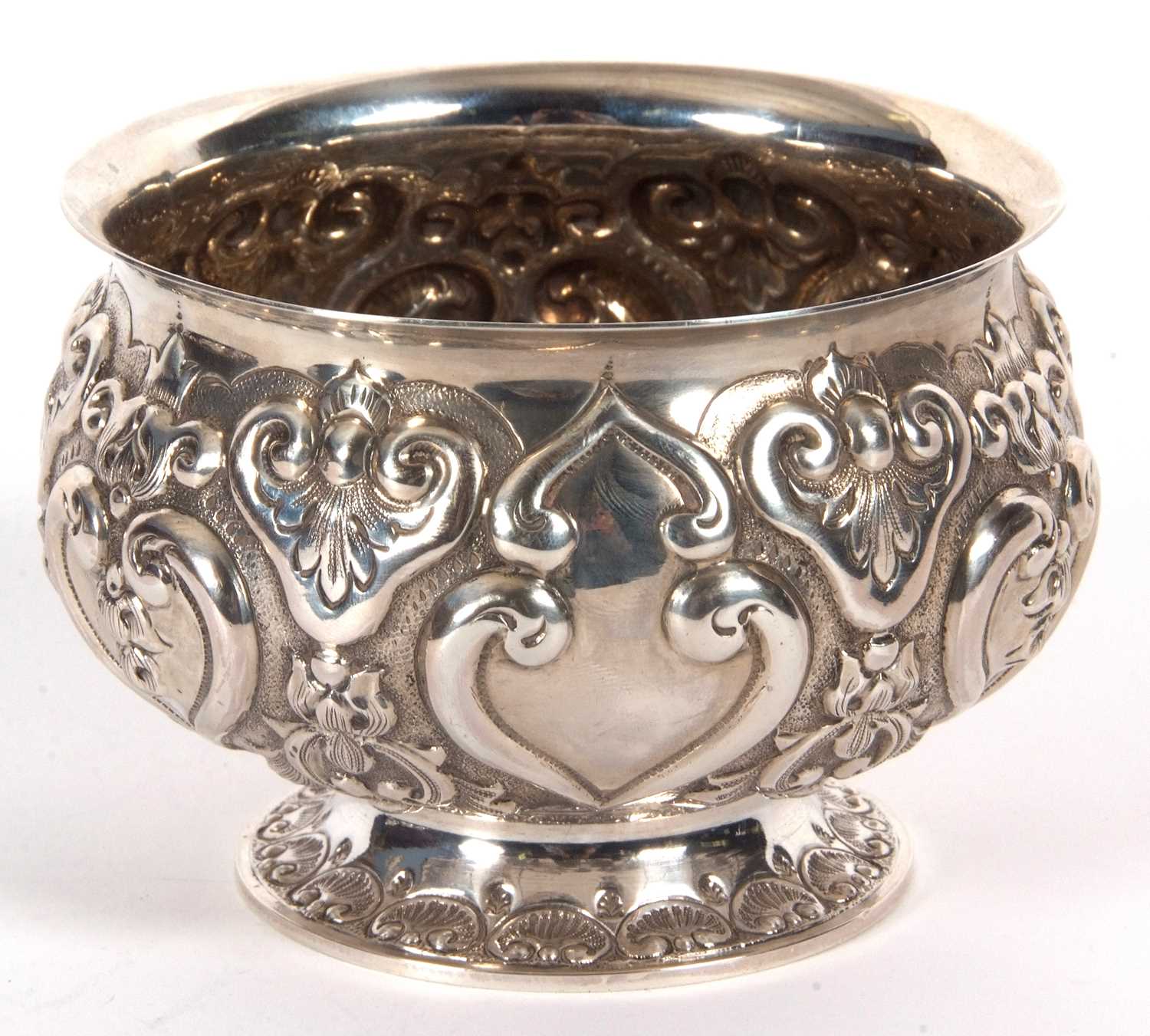 A late Victorian silver pedestal bowl of squat circular form, elaborately embossed all over with - Image 2 of 4