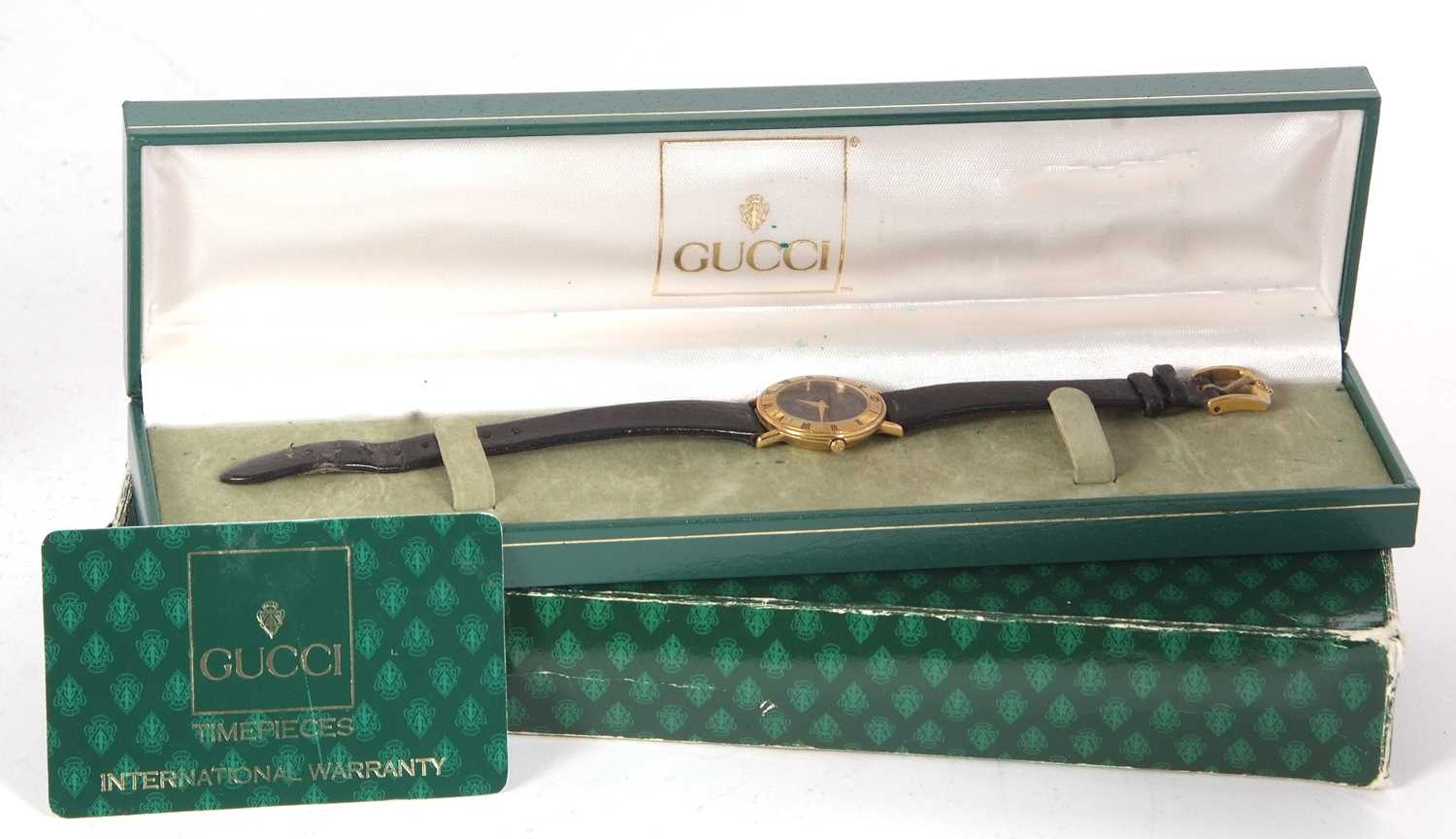 A ladies Gucci 3000L wristwatch, the outer box, box and warranty card are present, it has a quartz