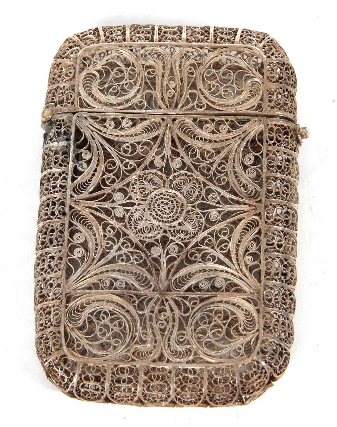 An antique Middle Eastern white metal filligree wire cigarette case, circa 1890 having a sprung