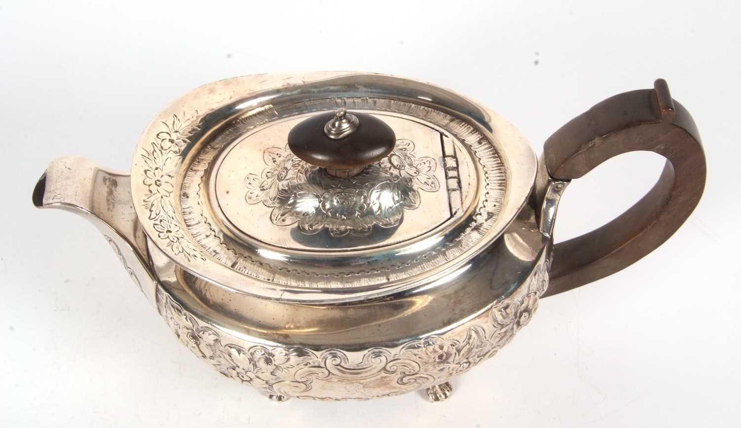 A George III silver teapot of oval form and elaborately decorated with scrolled flowers, - Image 3 of 4