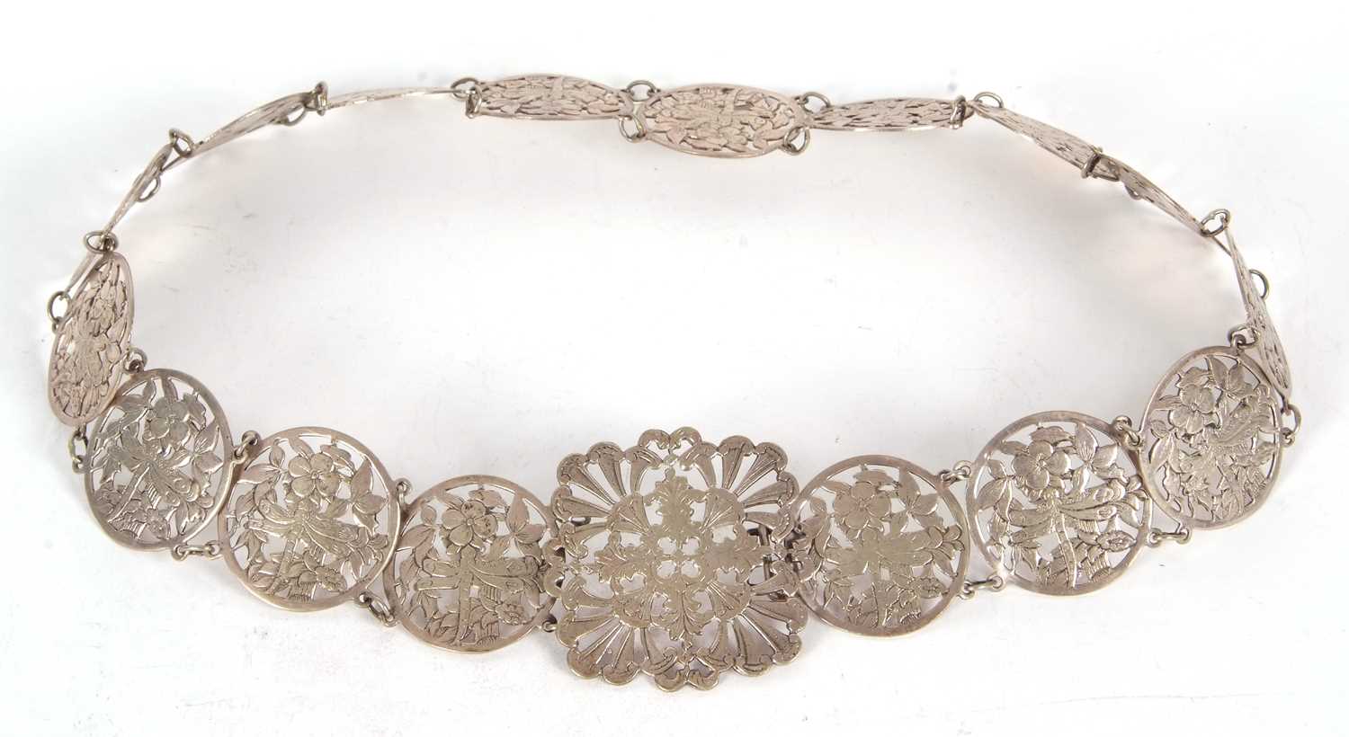 A vintage EPNS belt comprising sixteen circular pierced floral links to a square floral buckle, 68cm