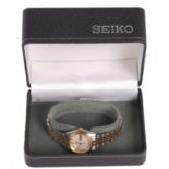 A ladies Seiko 5 automatic wristwatch, the watch has a two tone case and bracelet, a textured dial