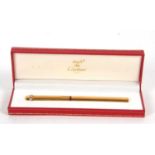 A Must de Cartier gold plated ballpoint pen No 559705 in original fitted Cartier box, 13.5cm long