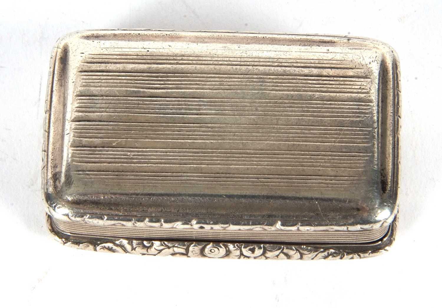 A George IV silver snuff box of rectangular form having cast foliate edges and thumb piece, engraved - Image 3 of 4