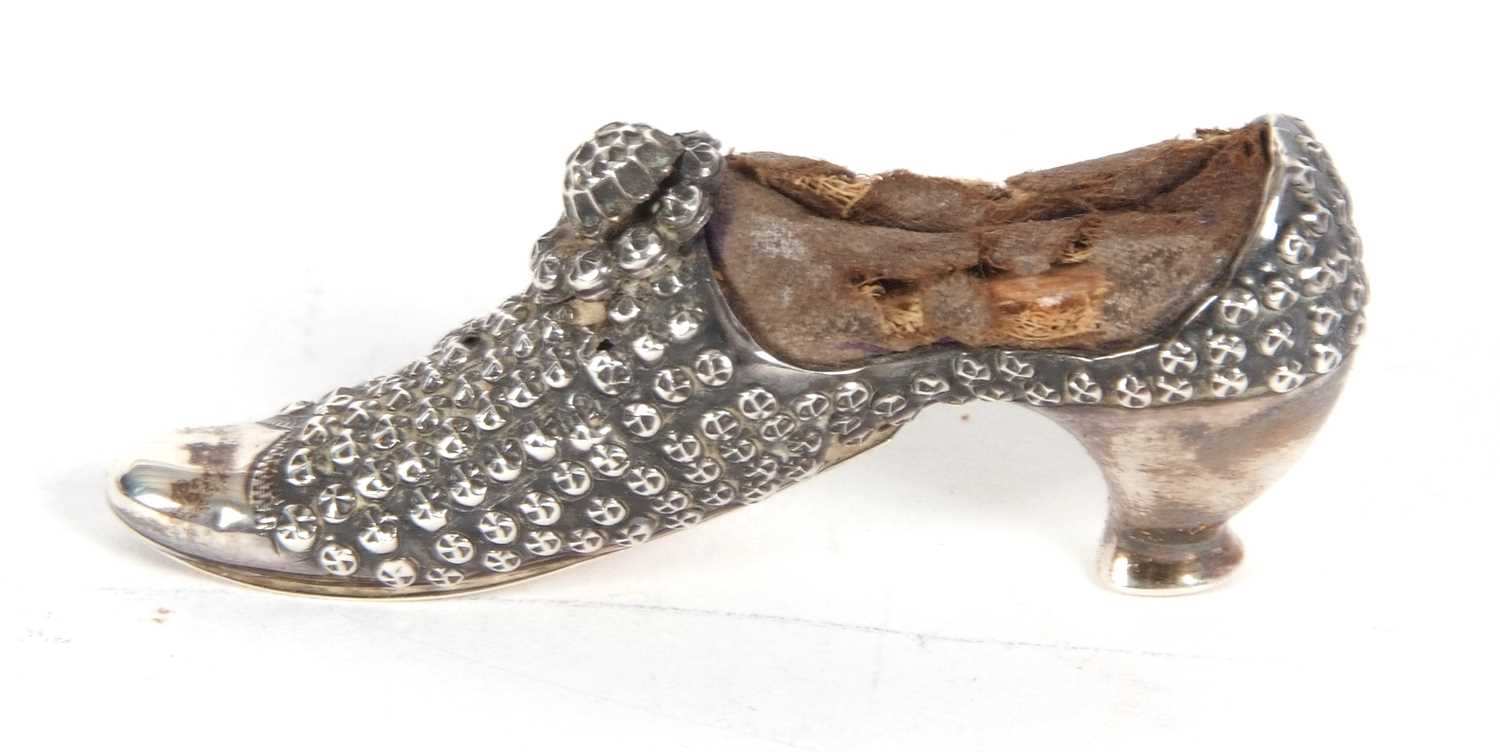 A Victorian silver pin cushion in the form of a shoe, hallmarked Birmingham 1895, makers mark for