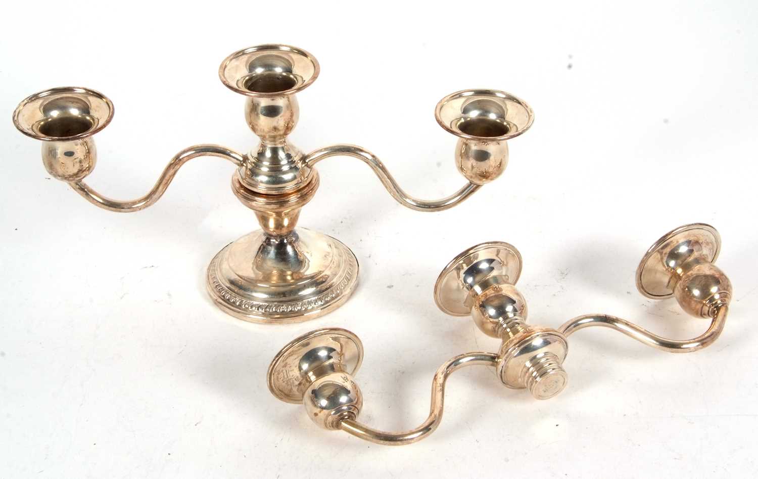 A small sterling twin branch candelabra, the top section with three lights on a pull off loaded base