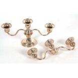 A small sterling twin branch candelabra, the top section with three lights on a pull off loaded base