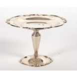 An Edwardian silver tazza, the shaped dish with applied gadrooned rim, supported on a plain tapering