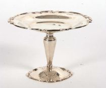 An Edwardian silver tazza, the shaped dish with applied gadrooned rim, supported on a plain tapering