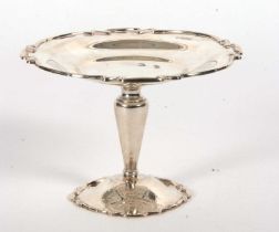 An Edwardian silver tazza, the shaped dish with applied gadrooned rim, supported on a plain tapering