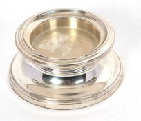 A hallmarked silver bottle stand, hallmarked for Birmingham 2003, makers mark W I Broadway, loaded