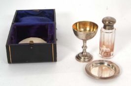An early 20th Century silver travelling communion set, chalice, paten and silver-necked bottle,