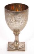 A George III silver goblet having engraved presentation, the ovoid cup with gilt interior, reeded