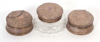 Pair of silver ring boxes of circular form, the hinged lids elaborately decorated with scrolls,