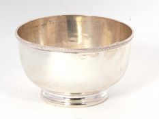 A George V small silver sugar bowl of plain circular form with applied beaded rim and supported on a
