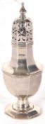 An Edwardian silver caster of octagonal form with pull off pierced lid, supported on a spreading