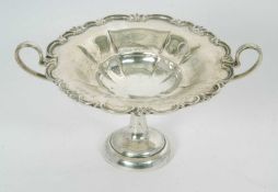 A small Edwardian silver twin handle tazza/dish, the shallow bow applied with a shell and scroll