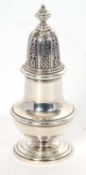An Elizabeth II heavy silver sugar sifter of baluster form, pull off pierced lid with urn finial and