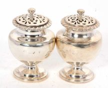 A pair of Georgian silver pounce pots, marks rubbed, 8cm tall, 106gms