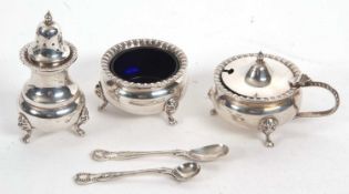 A hallmarked silver condiment set of plain round form comprising hinged lidded mustard, open salt